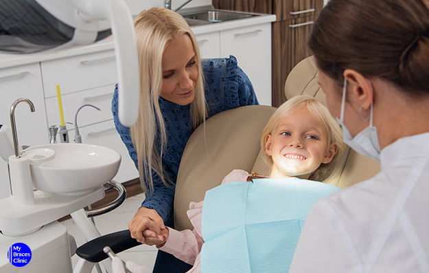 Girl having a checkup with an Orthodontist