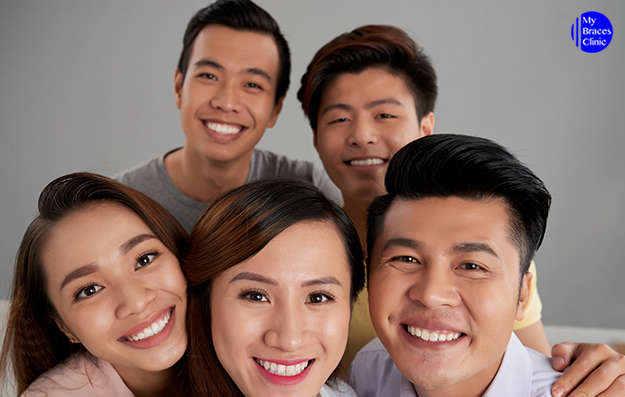 People Smiling with Straight Teeths after a visit to an Orthodontic Clinic