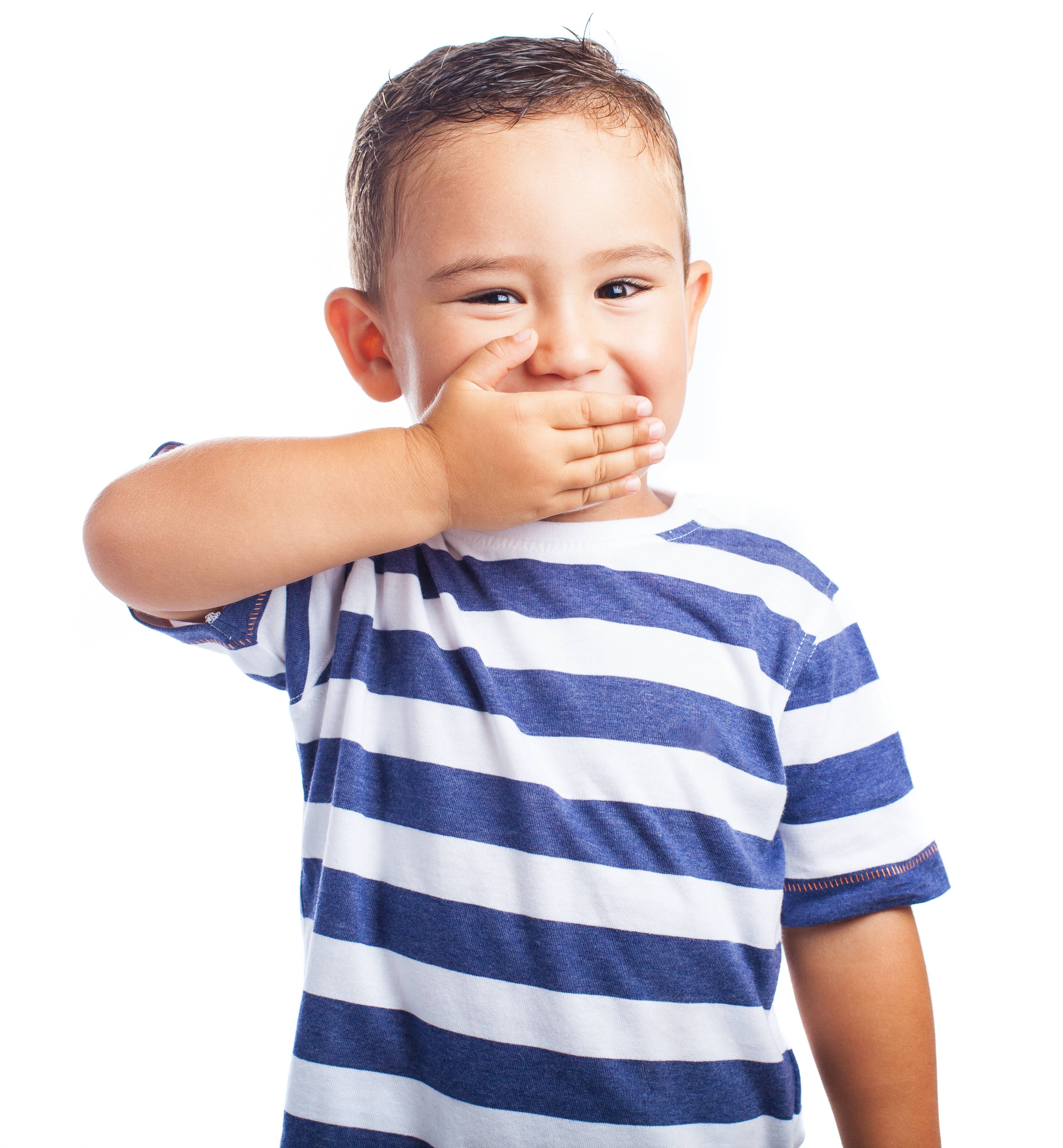 Little boy covering mouth